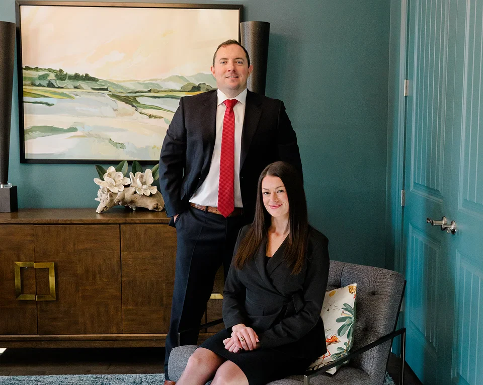 Chris Kinon standing and Caroline Barker seated at Kinon Law office