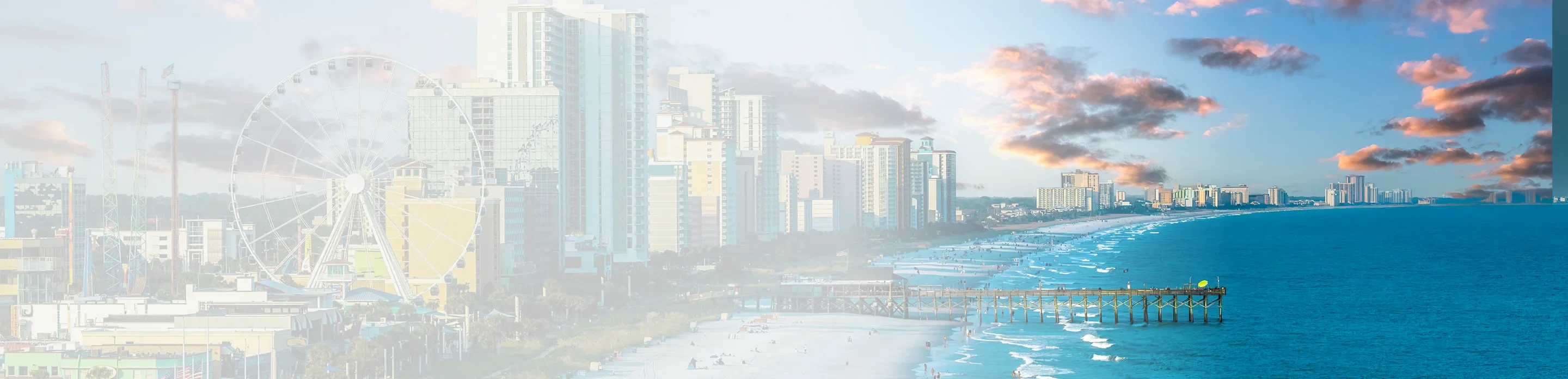 A vibrant coastal view featuring a beach, pier, and skyline with a Ferris wheel, under a colorful sky at sunset.